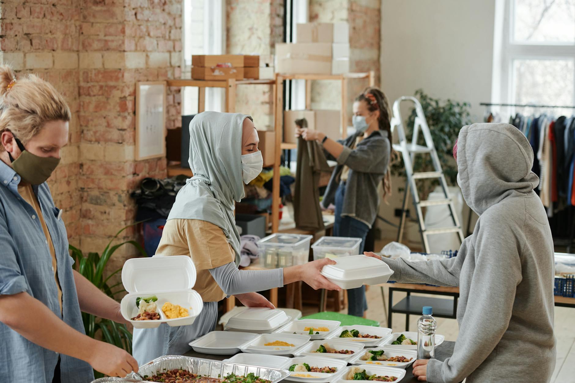 volunteers wearing face masks giving food